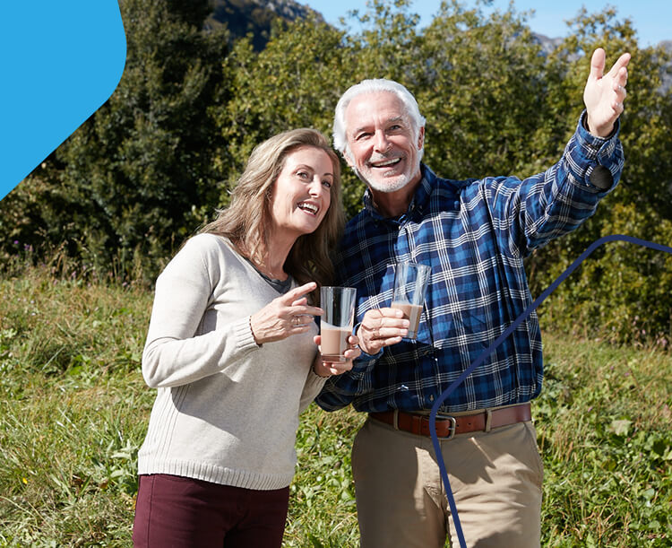 Image of a man and woman smiling and drinking a meal replacement shake